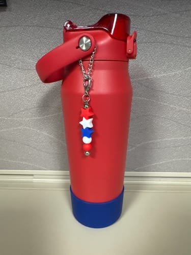 Customer's red Bottle Buddy 24oz with a blue bottom and a decorative star charm on the handle.