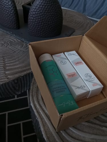 Customer's pack of 2 Lip Cream and a free Facewash inside an open cardboard box on a table.