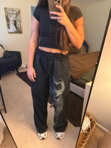 Reviewer wearing the baggy Divine Sweatpants with a rolled waistband, showing the skull graphic on the left leg.
