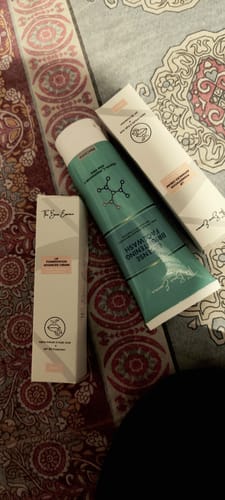 Customer's photo of the Lip Cream box and the free Facewash tube on a patterned surface.