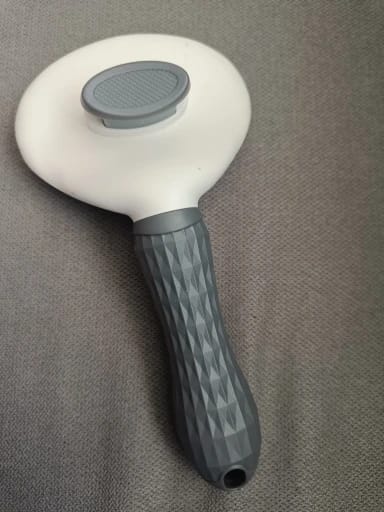 Customer photo review of Self Cleaning Pet Grooming Brush for Dogs and Cats