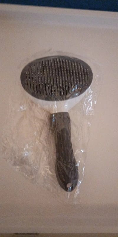 Customer photo review of Self Cleaning Pet Grooming Brush for Dogs and Cats