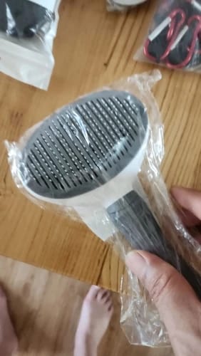 Customer photo review of Self Cleaning Pet Grooming Brush for Dogs and Cats