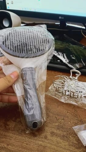 Customer photo review of Self Cleaning Pet Grooming Brush for Dogs and Cats