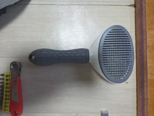 Customer photo review of Self Cleaning Pet Grooming Brush for Dogs and Cats