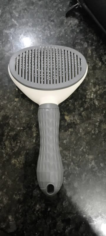 Customer photo review of Self Cleaning Pet Grooming Brush for Dogs and Cats