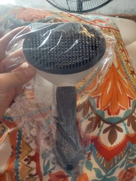 Customer photo review of Self Cleaning Pet Grooming Brush for Dogs and Cats