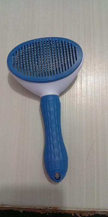 Customer photo review of Self Cleaning Pet Grooming Brush for Dogs and Cats