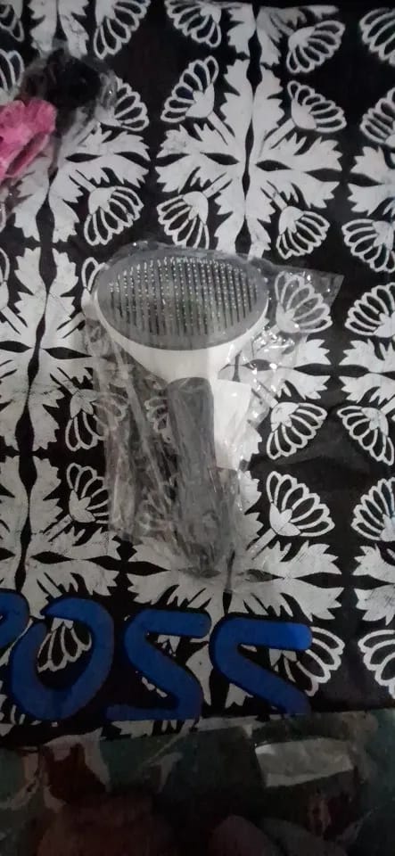 Customer photo review of Self Cleaning Pet Grooming Brush for Dogs and Cats