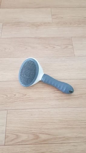 Customer photo review of Self Cleaning Pet Grooming Brush for Dogs and Cats