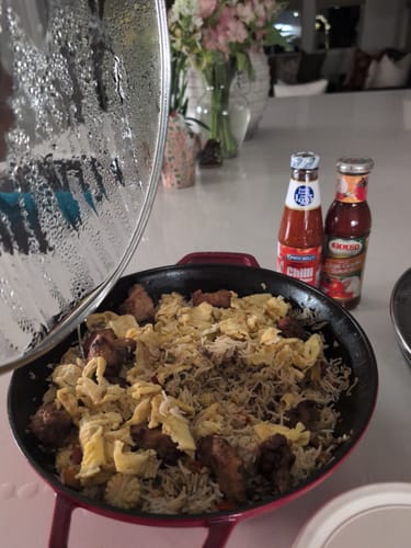 Customer's halal meat dish in a pan, now with rice and shredded egg added.