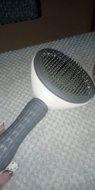 Customer photo review of Self Cleaning Pet Grooming Brush for Dogs and Cats