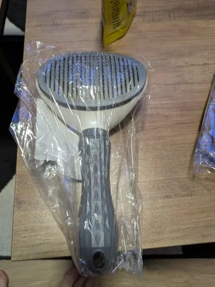 Customer photo review of Self Cleaning Pet Grooming Brush for Dogs and Cats