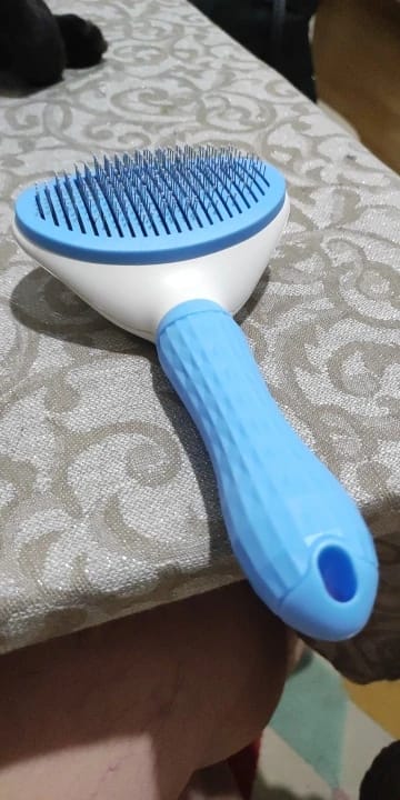 Customer photo review of Self Cleaning Pet Grooming Brush for Dogs and Cats