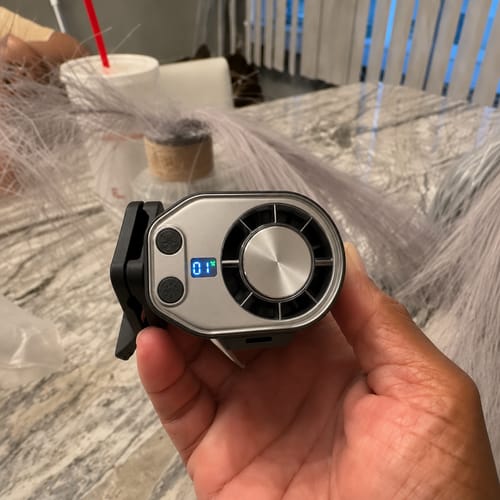 Customer holding the silver cooling fan