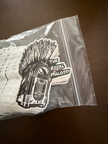 Customer's stack of custom Cut to Shape Stickers in a bag, showing a black and white jukebox design.