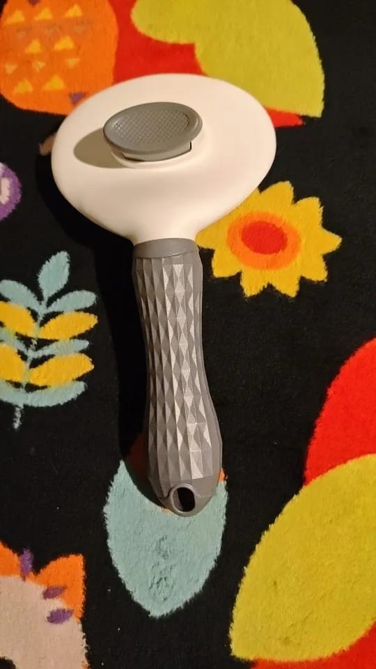 Customer photo review of Self Cleaning Pet Grooming Brush for Dogs and Cats