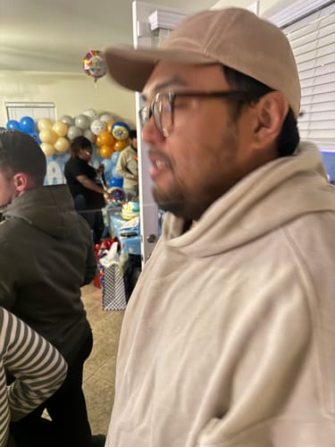 A customer wearing the light-colored Big Dad Hat Washed indoors at a party.