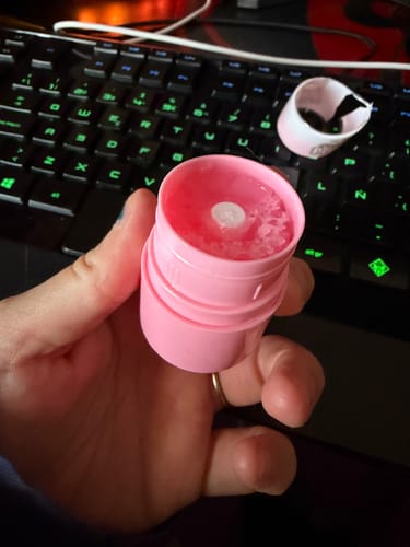 Customer holding the damaged Pass the Plump Magazine open, showing the pink balm inside.