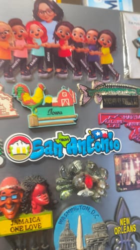 Customer's personalized Grandma Grandkids acrylic magnet displayed on a fridge among a collection of other magnets.