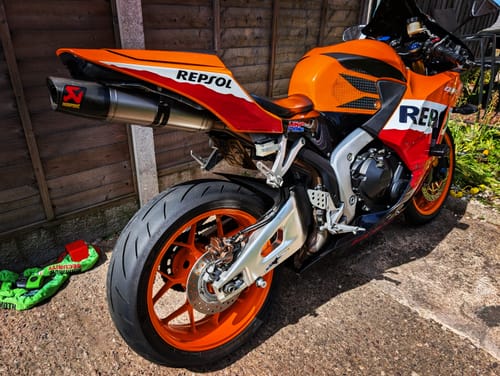 Customer's orange Honda CBR600RR motorcycle with the Integrated Rear Light installed, showing a clean tail section.