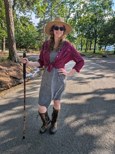 Reviewer standing on a wooded trail wearing the tall, camouflage Snakeproof Hunting Boots.