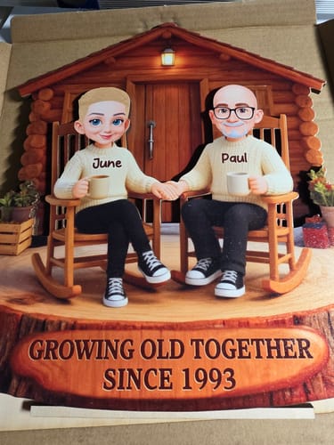 Customer's personalized wooden plaque showing a couple in rocking chairs, customized with names Paul and June and the year 1993.