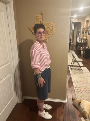 Customer showing a side view of the knee-length, dark wash Judy Blue High-Waist Jorts in a hallway.