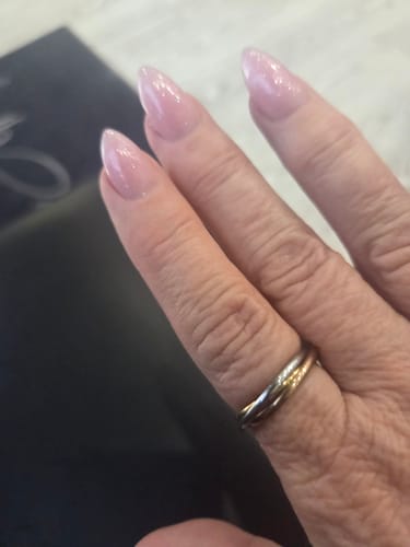 Close-up of a reviewer's hand wearing the tri-color Tidal Roller Ring.