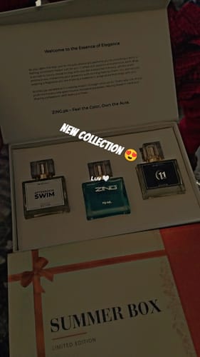 Reviewer's open Summer Box showing the three perfume bottles: Afternoon Swim, Bleu De Zing, and 11 PM.