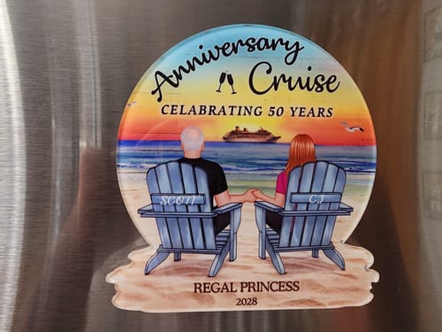 Customer's personalized cruise magnet on a metal surface, showing a couple on a beach from the back.