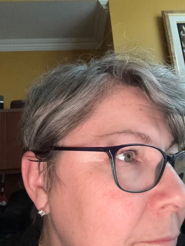 Close-up of a customer's face, showing their hair and skin around the eye area.