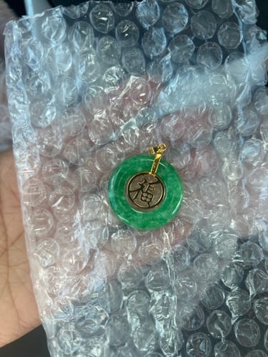 Customer showing the Jade Good Fortune pendant on bubble wrap, without the necklace chain.