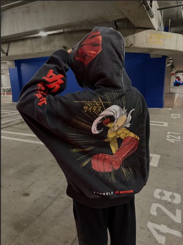 Customer wearing the oversized black One Punch Man Hoodie, seen from behind to display the full back graphic.