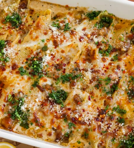 Close-up of a customer's baked Cajun pasta using Halal Chicken Thighs, topped with cheese and herbs.