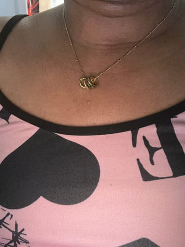 Close-up of a customer wearing a necklace with a ring pendant from the 12 pcs Spring Box Packaging.