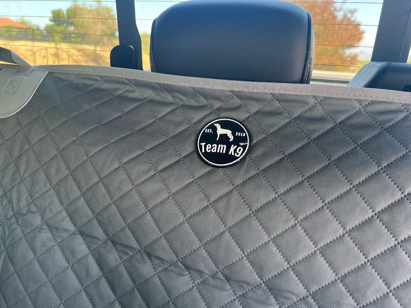 Customer photo review of NEW Waterproof Hard Bottom Car & Truck Seat Foldable Hammock Cover With Storage Pockets, Side Flaps, Headrest Straps, Seat Anchors, & Mesh Window (+FREE SAFETY BELT!)