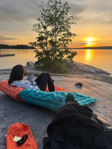 Couple on Adventure Mats at sunset by the lake