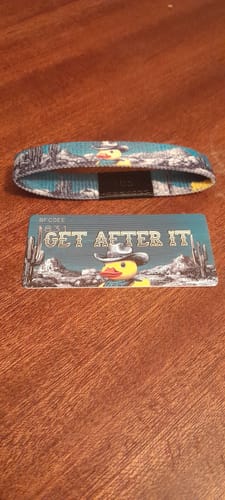 Customer's 'Get After It' bracelet and matching card, showing the cute cowboy rubber duck design on a wooden table.