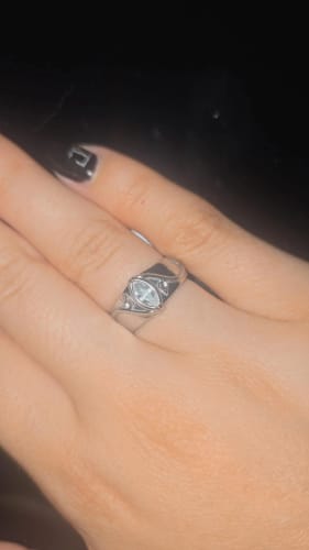 Close-up of a reviewer's hand wearing the silver-toned Birthstone Ring, highlighting the marquise-shaped center stone.
