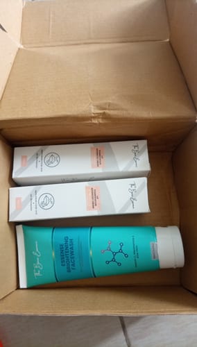 Customer showing the unboxed Pack of 2 Lip Cream and FREE Facewash inside the delivery box.