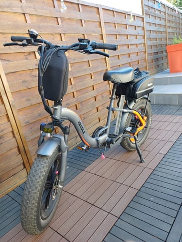 Customer's grey Vakole Y20 Pro e-bike with fat tires and a handlebar bag parked on a patio.