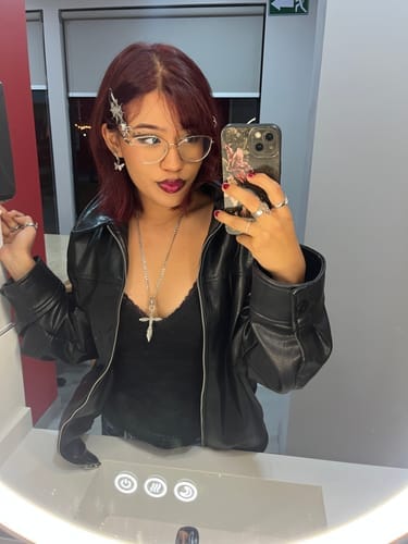Nadia wearing a silver hair clip with glasses and a black jacket