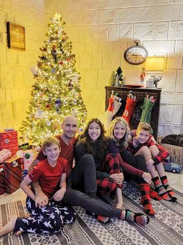 Customer's family photo for a custom paint-by-number kit, showing five people by a Christmas tree.