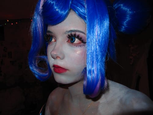 Reviewer in cosplay shows off large, vibrant eyes using Halloween Miracle Sapphirl contacts.