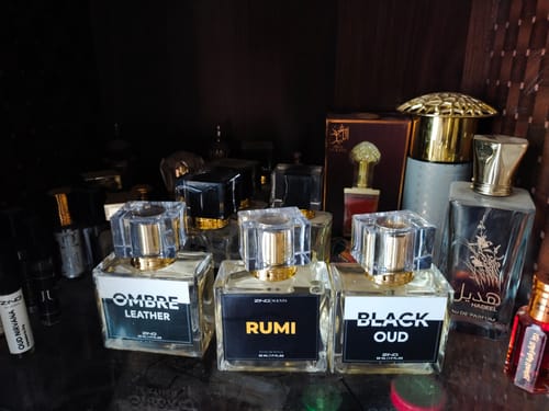 Customer's three fragrances from the Winter Box—Ombre Leather, Rumi, and Black Oud—on a shelf with other perfumes.