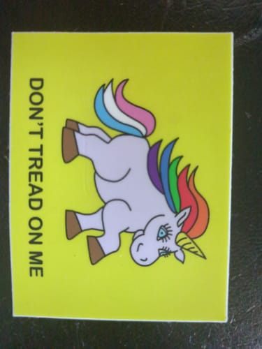 Customer's bright yellow custom vinyl sticker showing a cartoon unicorn and the text 'DON'T TREAD ON ME'.