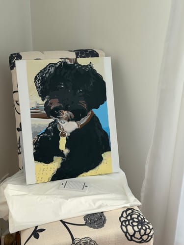 Customer's completed paint-by-numbers canvas showing a portrait of a fluffy black dog.