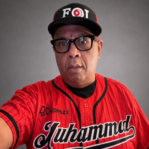 image 1 out of 2: Customer wearing a custom red and black pinstripe baseball jersey with 'Muhammad' stitched on the front.