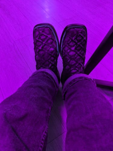 Customer's point-of-view wearing their textured, square-toed Jumbo Pirarucu Leather Boots indoors.